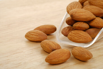 Almonds on wooden background. Healthy food concept.