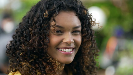 One happy black girl with curly smiling. Portrait face closeup of a Brazilian hispanic African American young woman