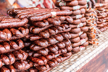 Various types of smoked sausages piled up for sale in the market