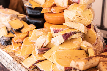 Assortment of cheeses of various textures and colors for sale by a street vendor