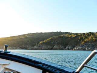 View to land from the ship at sea with sunset