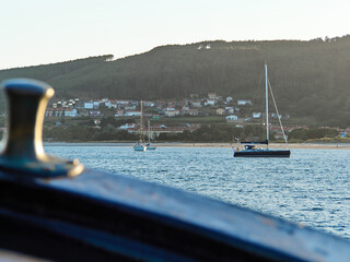 Sailboats and a small coastal village seen from the sea