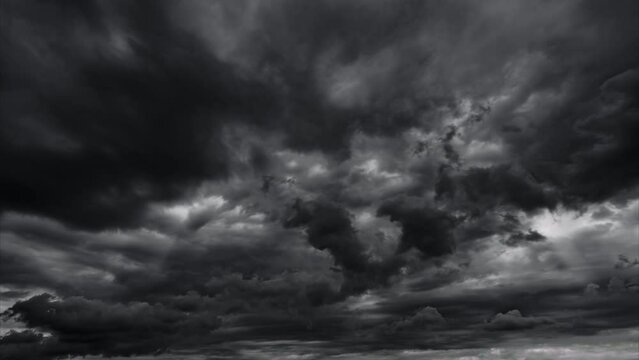 timelapse of dark dramatic sky with black stormy clouds before rain or snow as abstract background, wind and extreme weather