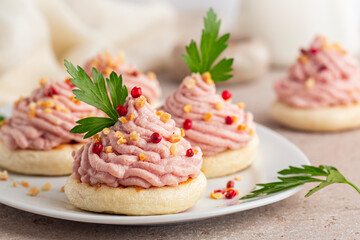Beautiful Italian canapes with mortadella and ricotta cream mousse or Spuma di mortadella on a small tigelle bread. Appetizer or snacks for a festive table. - obrazy, fototapety, plakaty