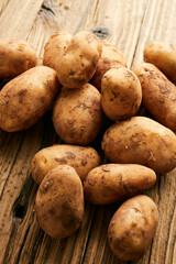 Potatoes over wooden vintage backdrop