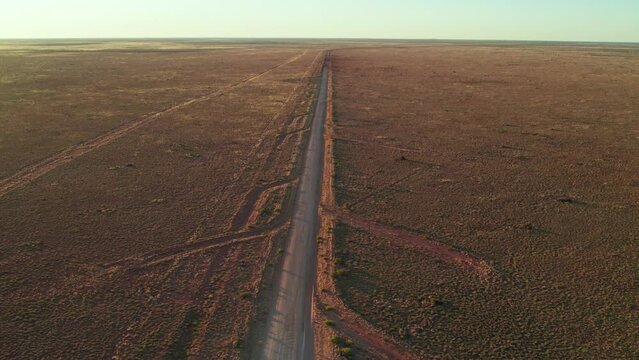 Drone footage looking south-west along the Tanami Road with mitre drains, in the Tanami Desert, Northern Territory, Australia. August 2022.