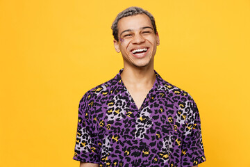 Young laughing smiling happy fun cheerful cool gay man wearing purple animal print shirt looking...