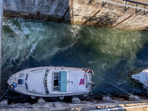 Boat in a lock navigating up river in one of the several staircase locks in the Telemark Canal, Telemark og Vestfold, Norway