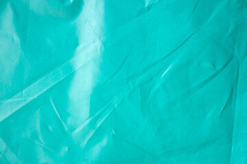 Blue wrinkled plastic bag texture background close up