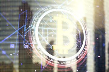 Virtual Bitcoin hologram on office buildings background. Multiexposure