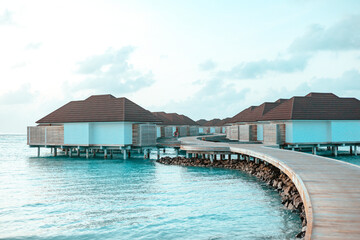 picturesque sunrise in the Maldive island, view on water villas at sunrise in Maldives, concept of luxury travel and vacation