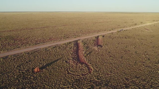 Drone footage crossing the Tanami Road with mitre drains, in the Tanami Desert, Northern Territory, Australia. August 2022.