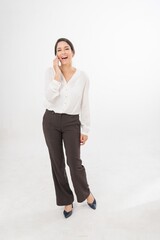 Studio portrait photo of a young beautiful elegant Brazilian female businesswoman lady wearing smart casual business attire posing with a series moments of emotion and gesture of using her smartphone