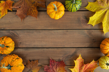 Autumn flat lay rustic composition frame for Thanksgiving or Halloween. Variety of edible and...
