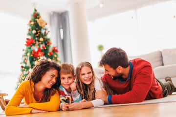 Parents and children celebrating Christmas at home