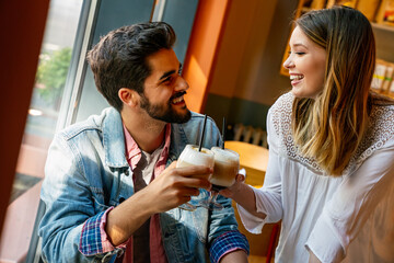 Romantic loving couple drinking coffee, having a date in the cafe.