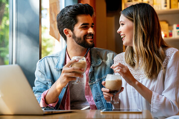 Romantic loving couple drinking coffee, having a date in the cafe.