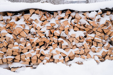 textured firewood background chopped wood for kindling and heating. woodpile with stacked firewood...