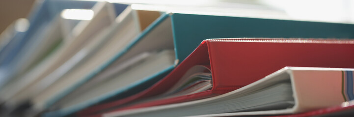 Colored folders lie on the table, blurry