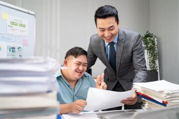Asian young businessman with down syndrome working in office workplace. 