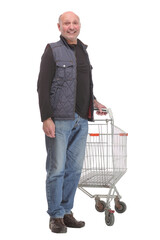 Elderly man pushing a shopping cart isolated on white background