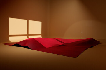Red cloth in sunlit small golden room. Product stage template