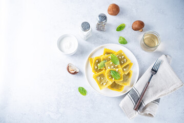 Fresh prepared Ravioli pasta with mushrooms and cheese in a plate