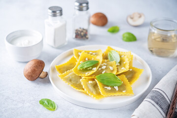 Fresh prepared Ravioli pasta with mushrooms and cheese in a plate