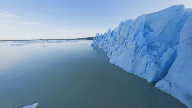 FPV drone shot flying over glacier ice and through a crevasse on the wall, in Vatnajokull, Iceland