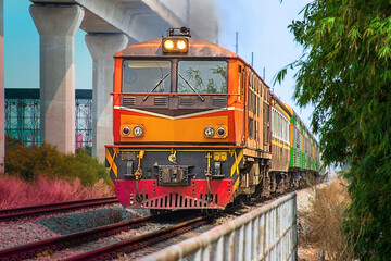 Obraz premium Passenger train by diesel locomotive on the railway.