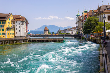 LUCERNE, SWITZERLAND, JUNE 21, 2022 - The rushing waters of the Reuss River in the center of...