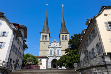 Fototapeta na wymiar LUCERNE, SWITZERLAND, JUNE 21, 2022 - View of the Court Church of Saint Leodegar (Hofkirche Sankt Leodegar) in Lucerne, Switzerland