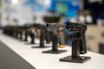 Fototapeta na wymiar Pistols Lined Up in the Gun Shop