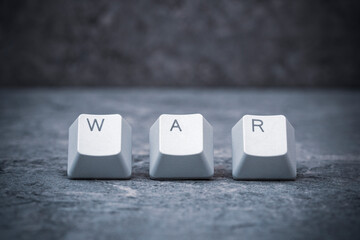 Computer keyboard keys arranged to spell WAR word