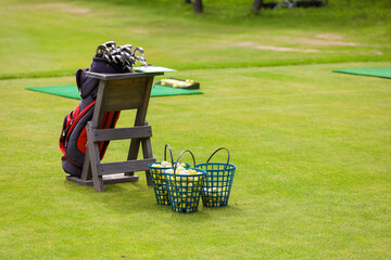 The Golf club bag for golfer training and play in game with golf course background , green tree sun...