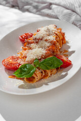 Homemade Bucatini, Amatriciana Pasta with bacon, cherry tomatoes and parmesan