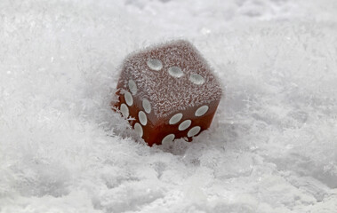 A die on snow, concept of luck or frozen chance