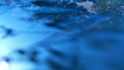 car metal hood, part of vehicle bodywork, steel gradient line pattern, selective focus. Blue background, metal paintwork texture. Car paint. Reflections in the polished surface of blue lacquer paint.