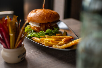 Hamburger with french fries on a wood table
