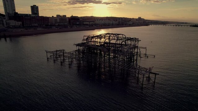 Beautiful footage as drone circles West Pier Brighton as sun rises behind