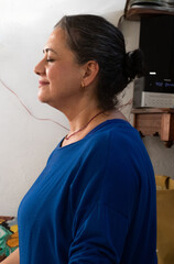 Fototapeta premium middle-aged yoga teacher is relaxed on her mat as she supervises her students in a private class.