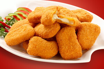 Fried chicken nuggets and sauce, isolated on gray.