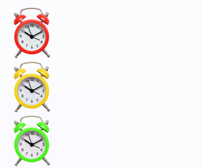 Three multi-colored traffic light alarm clocks on a white background with free space for text. Green yellow and red mechanical alarm clock. The concept of punctuality and responsibility