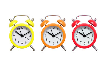 Three multi-colored alarm clocks on a white background. Yellow orange and red alarm clock on an...