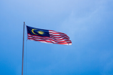 Malaysian Flag waving with blue sky background