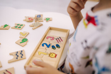 Children in kindergarten put together educational puzzles