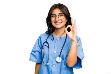 Young nurse Indian woman isolated cheerful and confident showing ok gesture.