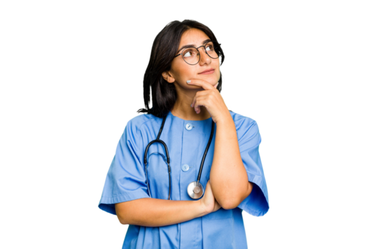 Young nurse Indian woman isolated looking sideways with doubtful and skeptical expression.