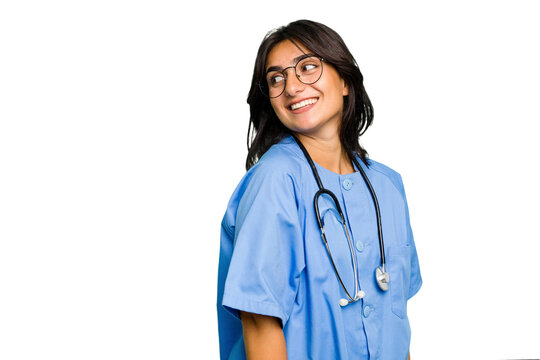 Young nurse Indian woman isolated looks aside smiling, cheerful and pleasant.