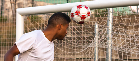 Soccer player scoring a header goal. Soccer man on the pitch scoring a header goal. Concept of goal...